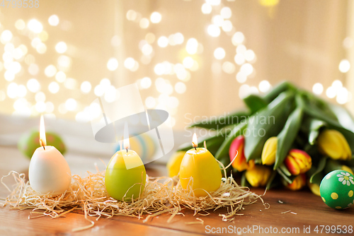 Image of candles in shape of easter eggs and tulip flowers