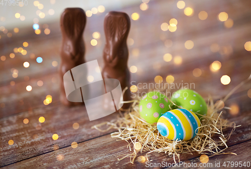 Image of easter eggs in straw nest and chocolate bunnies