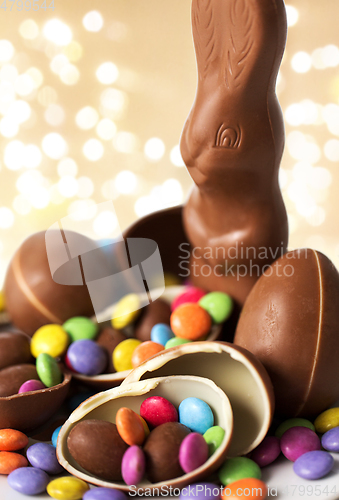 Image of close up of chocolate bunny, eggs and candy drops