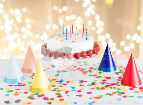 Image of birthday cake with candles and strawberries