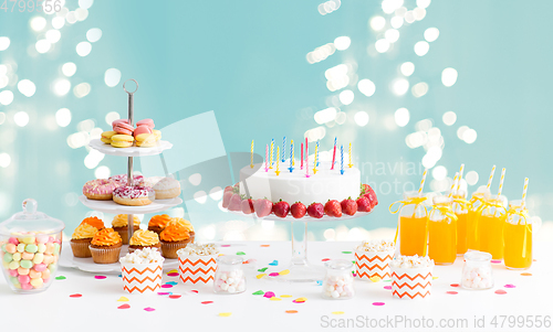 Image of food and drinks on table at birthday party