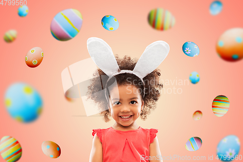 Image of happy little girl wearing easter bunny ears