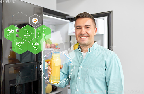 Image of man taking juice from fridge at home kitchen