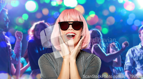 Image of happy woman in pink wig and sunglasses at party