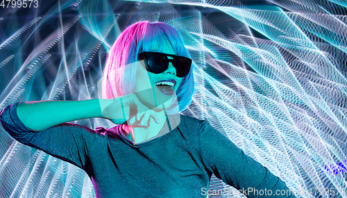 Image of happy woman in pink wig and black sunglasses