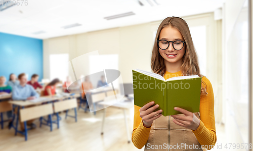 Image of teenage student girl in glasses reading book