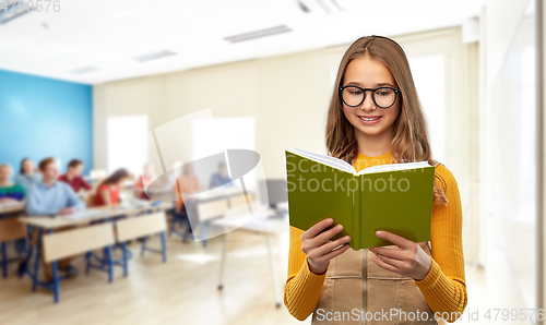 Image of teenage student girl in glasses reading book