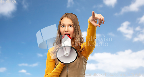 Image of teenage girl speaking to megaphone over sky