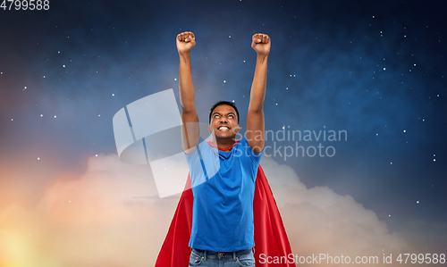 Image of indian man in superhero cape flying in night sky