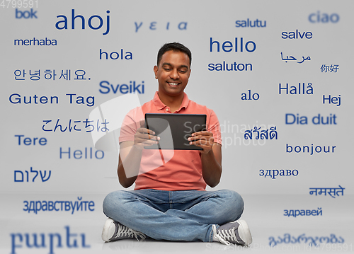 Image of happy indian man with tablet pc