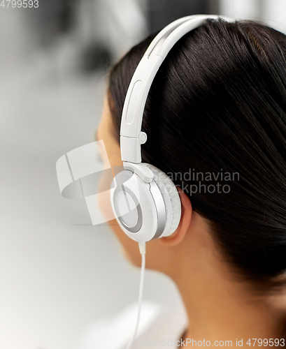 Image of close up of woman in headphones listening to music