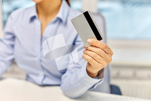 Image of businesswoman with credit card at office