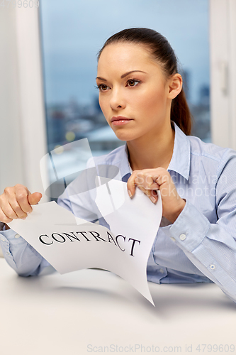 Image of businesswoman terminating contract at office