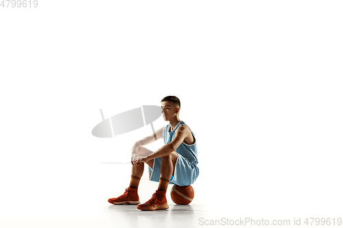 Image of Full length portrait of a young basketball player with ball