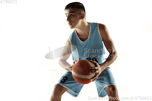 Image of Full length portrait of a young basketball player with ball