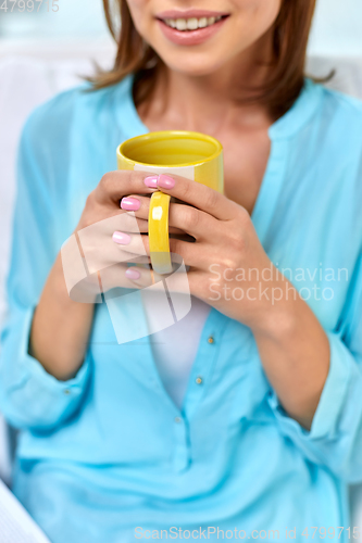 Image of close up of happy woman with cup of tea or coffee