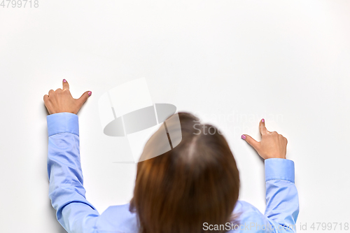 Image of businesswoman touching white table with fingers