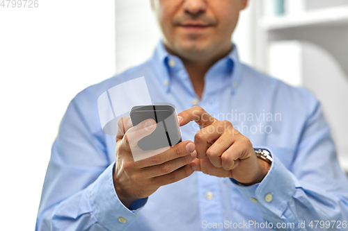 Image of close up of businessman using smartphone