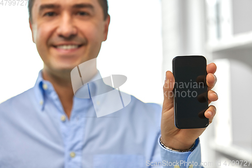Image of happy businessman showing smartphone screen
