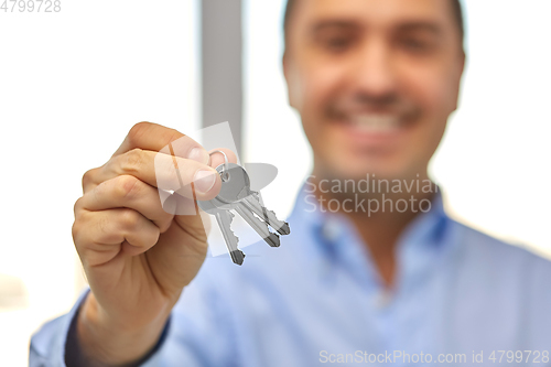 Image of close up of smiling man holding house keys