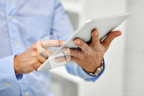 Image of close up of male hands with tablet pc computer