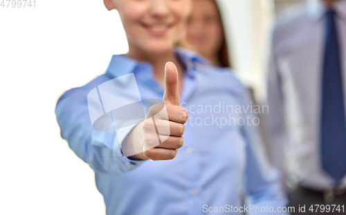 Image of close up of happy businesswoman showing thumbs up