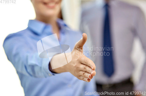 Image of businesswoman making handshake at office