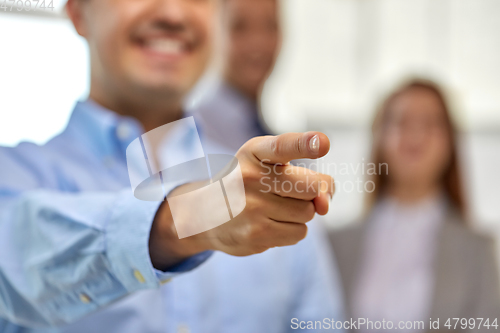 Image of close up of smiling businessman pointing finger