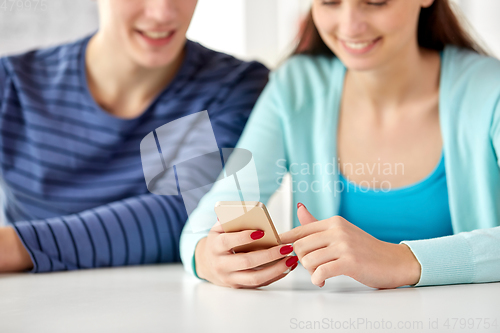 Image of close up of female hands with smartphone