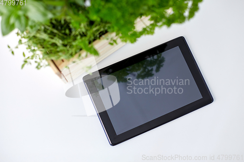 Image of tablet computer with herbs and flowers in box