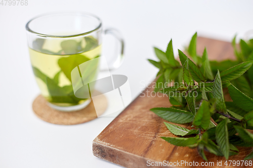 Image of herbal tea with fresh peppermint on wooden board