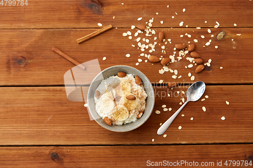 Image of oatmeal with banana and almond on wooden table