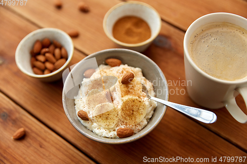 Image of oatmeal with banana and almond on wooden table