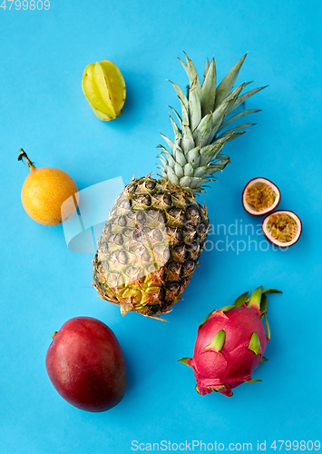 Image of pineapple with other fruits on blue background