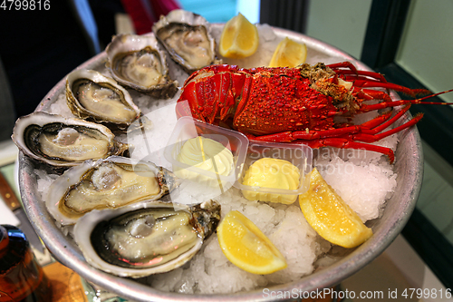 Image of Large dish with fresh seafood, oysters with lobster with lemon a
