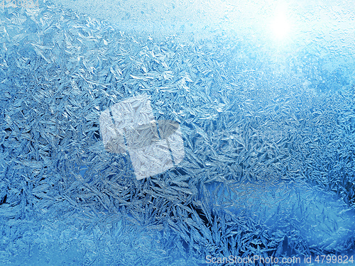 Image of Beautiful ice pattern and sunlight close-up on winter glass
