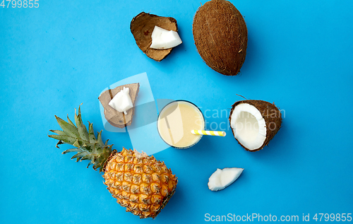 Image of pineapple, coconut and drink with paper straw