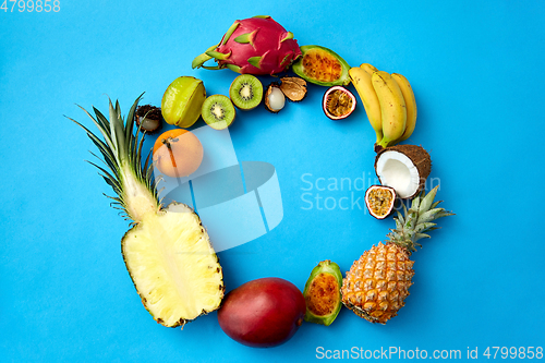 Image of different exotic fruits on blue background