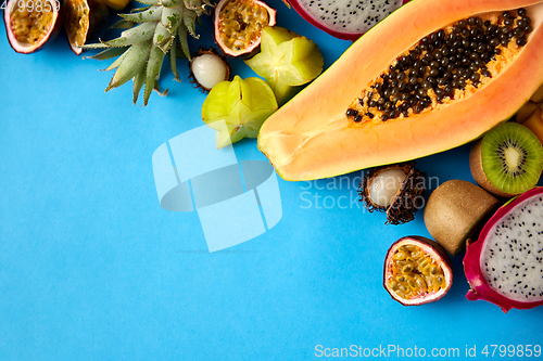 Image of different exotic fruits on blue background