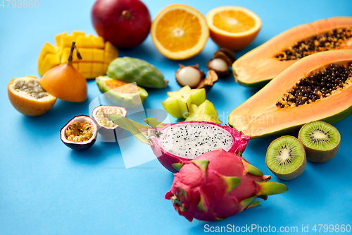 Image of different exotic fruits on blue background