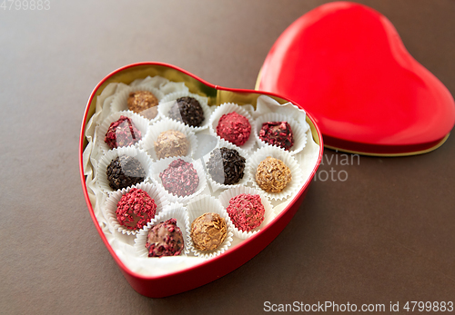 Image of candies in red heart shaped chocolate box