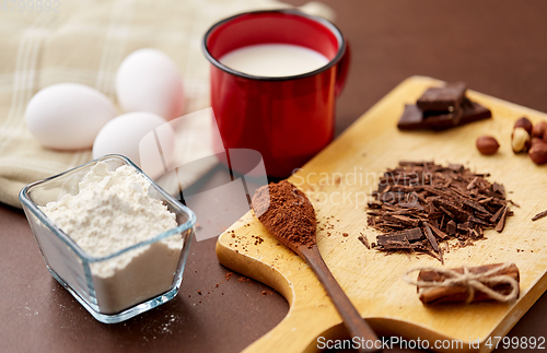 Image of chocolate, cocoa powder, milk, eggs and flour