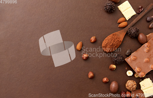 Image of chocolate with nuts, cocoa beans and powder