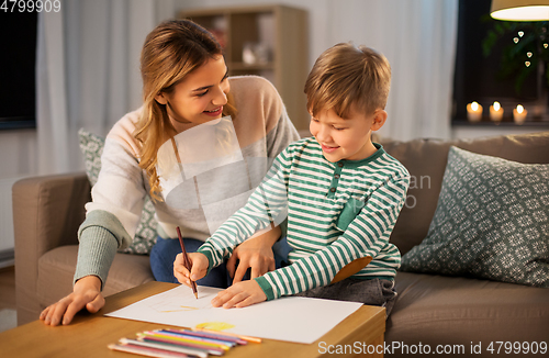 Image of mother and son with pencils drawing at home