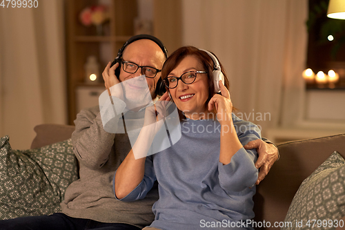 Image of senior couple with headphones listening to music