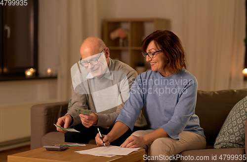 Image of senior couple with bills counting money at home