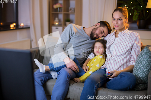 Image of tired sleepy family watching tv at home at night