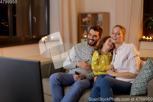 Image of happy family watching tv at home at night