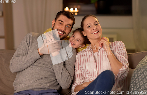 Image of portrait of happy family sitting on sofa at home