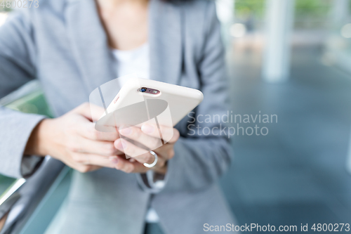 Image of Businesswoman use of mobile phone at outdoor
